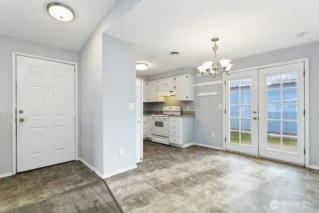 a view of a kitchen with refrigerator and a sink