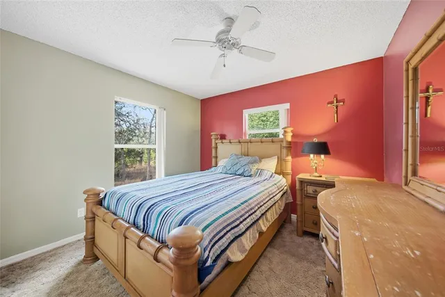 a bedroom with bed and window