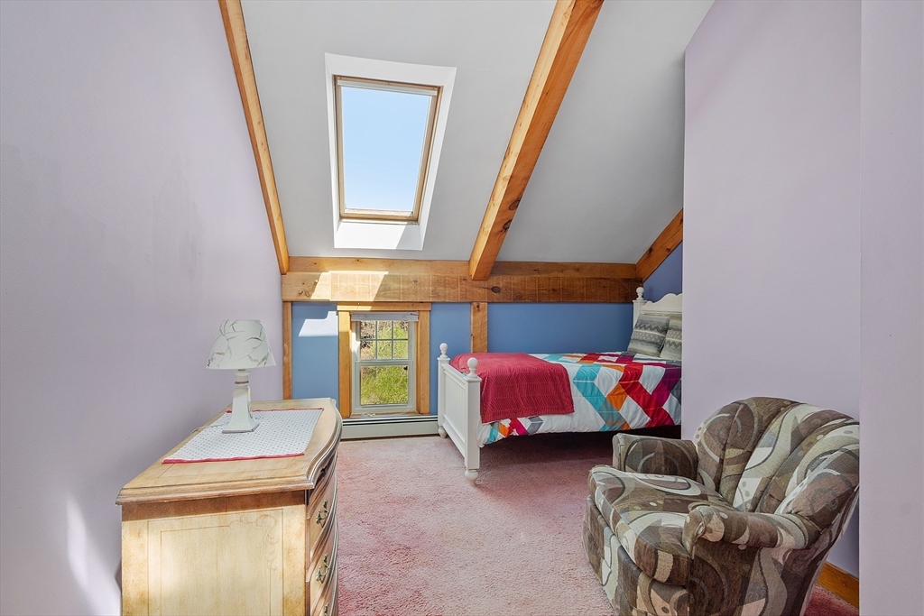 31 Dutton Road Pelham, NH 03076 - Photo 20 of 36 a bedroom with a bed and a couch
