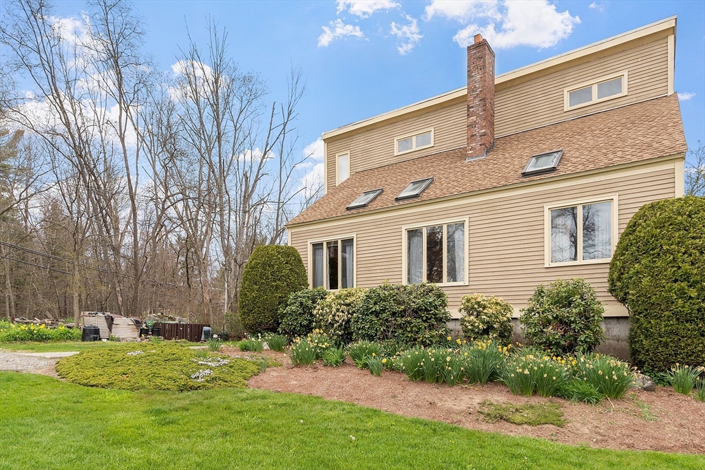 31 Dutton Road Pelham, NH 03076 - Photo 2 of 36 a front view of a house with a yard