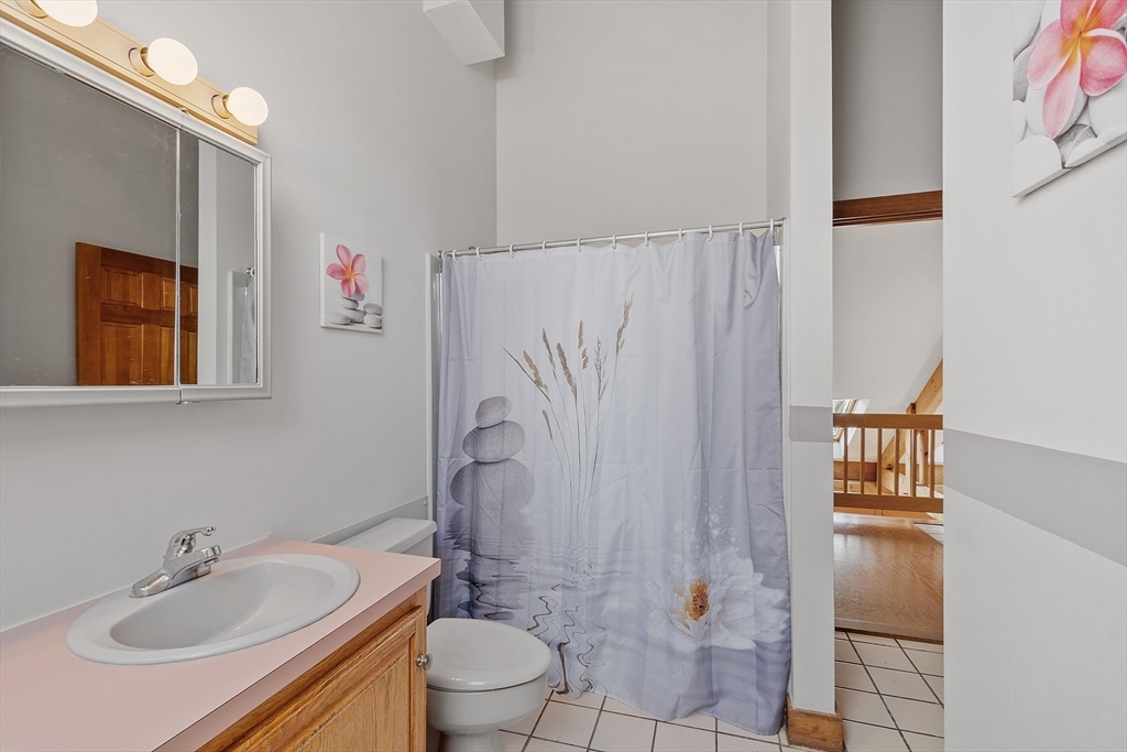 31 Dutton Road Pelham, NH 03076 - Photo 23 of 36 a bathroom with a sink toilet and shower