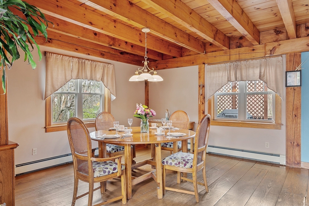 31 Dutton Road Pelham, NH 03076 - Photo 7 of 36 a dining room with furniture and a table with wooden floor