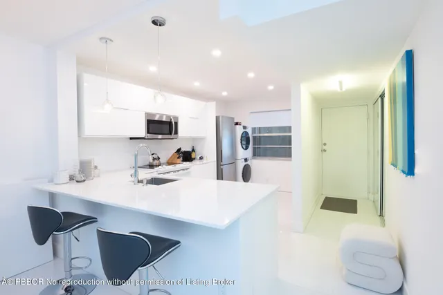 a kitchen with stainless steel appliances kitchen island granite countertop a sink and cabinets