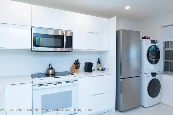 a utility room with sink washer and dryer