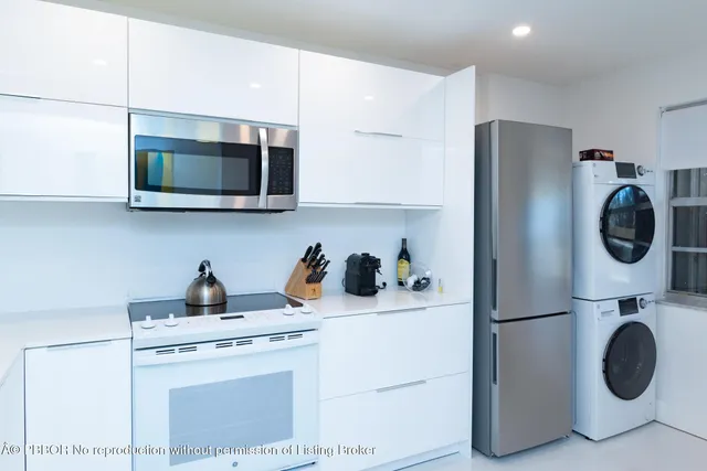 a utility room with sink washer and dryer