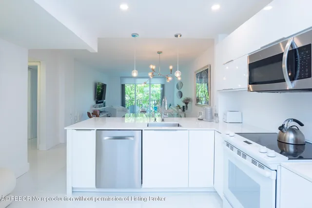 a kitchen with stainless steel appliances granite countertop a sink and a microwave