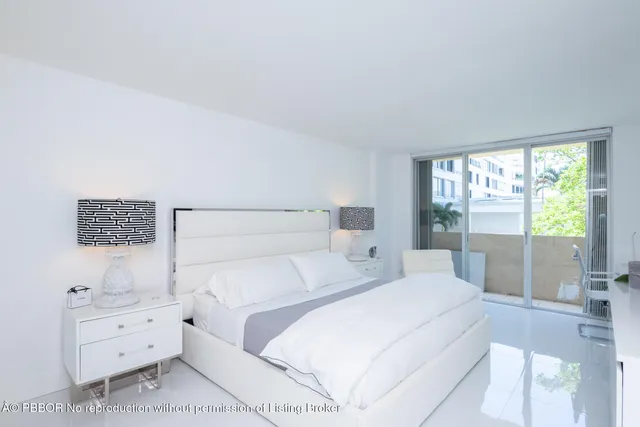 a bedroom with a bed and a night stand