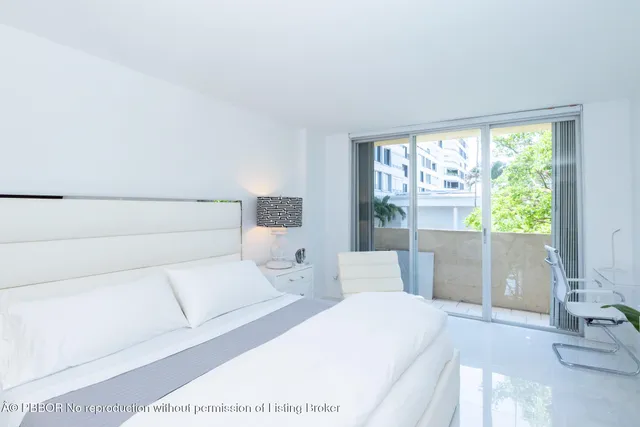 a bed room with a bed and a large window