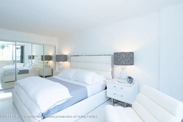 a large white bed in a white room