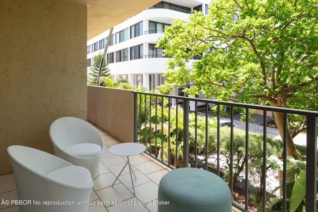 a view of a chairs and table in the balcony