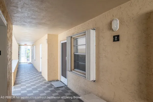 a view of a hallway with wooden floor and glass door