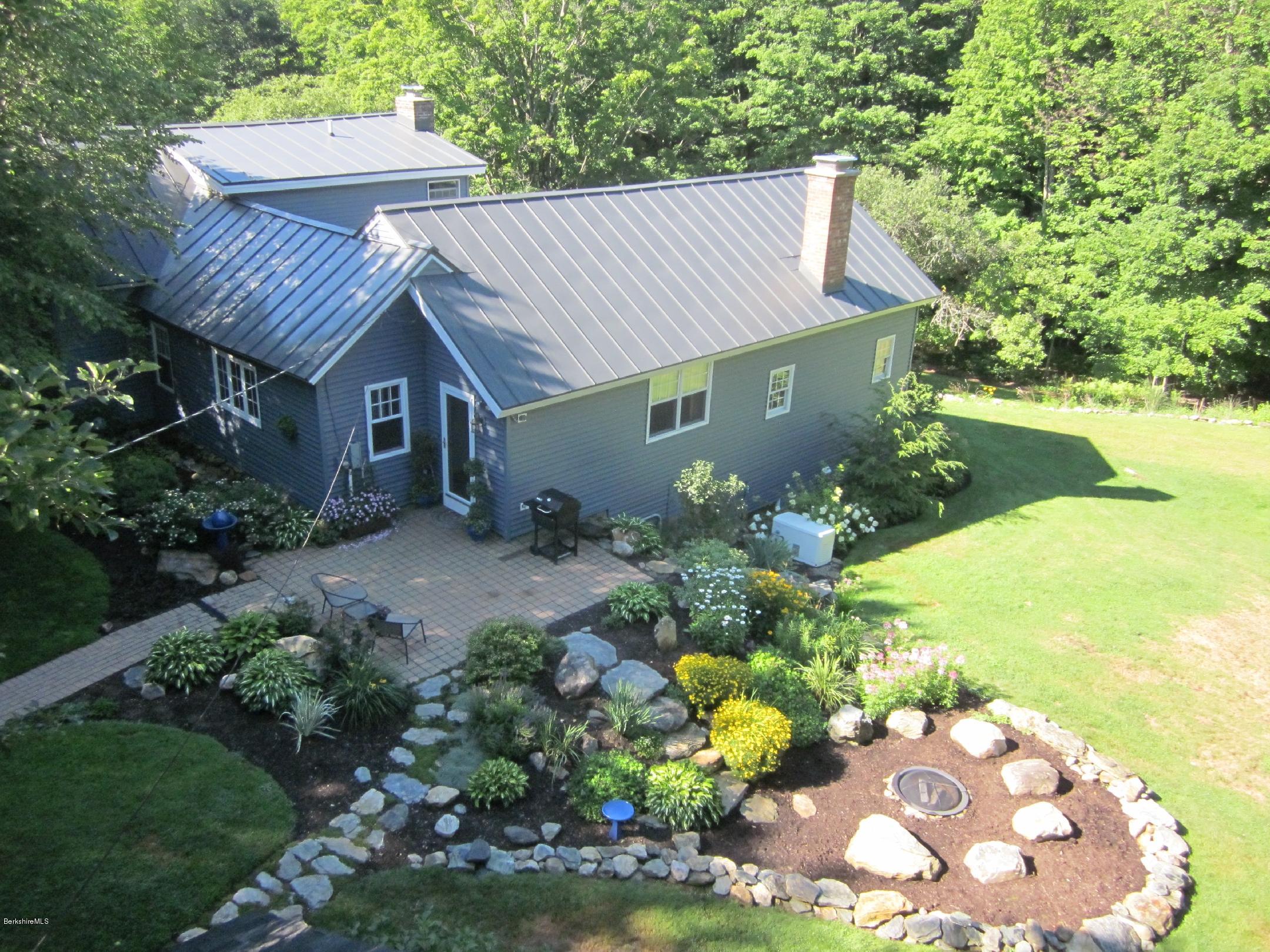 661 High St Hill Road Windsor, MA 01270 - Photo 1 of 75 a view of a white house with a yard and garden