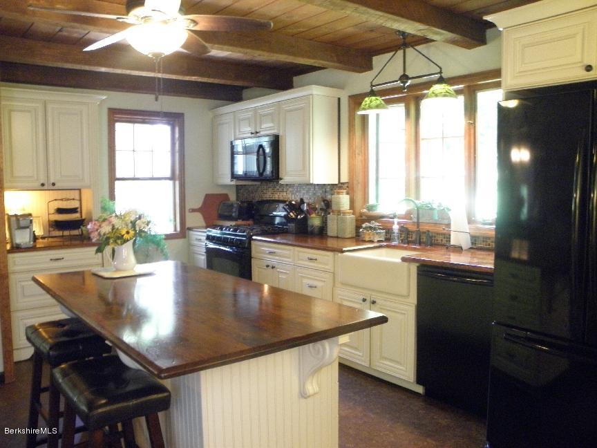 661 High St Hill Road Windsor, MA 01270 - Photo 14 of 75 a kitchen with a table chairs stove and cabinets