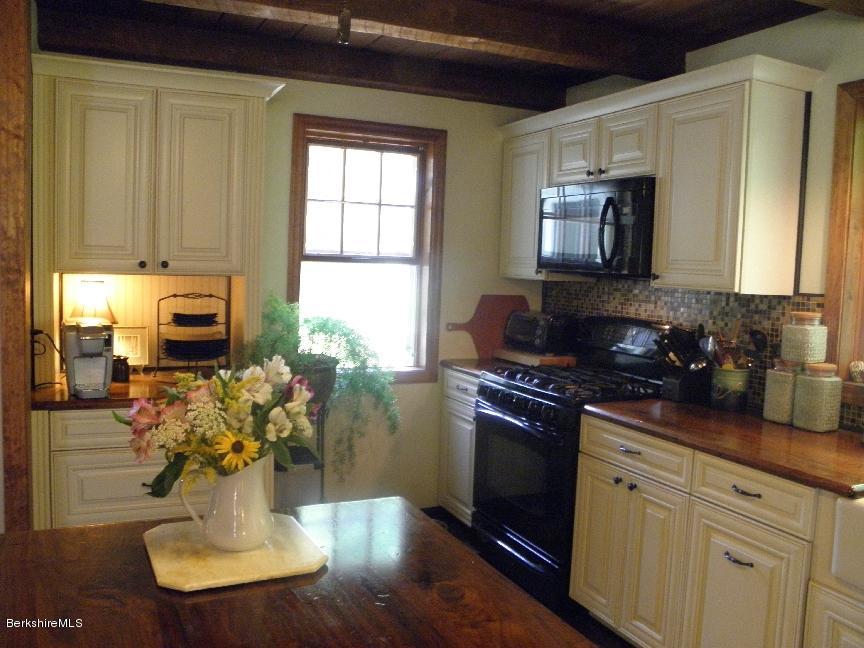 661 High St Hill Road Windsor, MA 01270 - Photo 17 of 75 a kitchen with stainless steel appliances granite countertop a refrigerator a stove a sink dishwasher with a dining table and chair with wooden floor