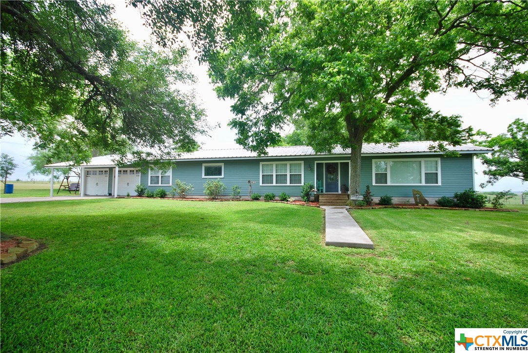 104 County Road Moulton, TX 77975 - Photo 1 of 1 a front view of house with a garden and porch