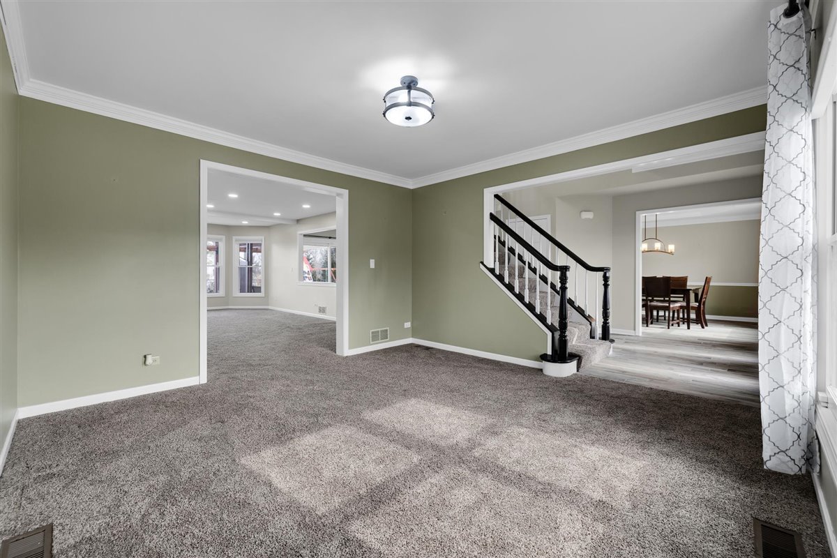 607 Cottage Road Batavia, IL 60510 - Photo 11 of 36 a view of a hallway with a livingroom and a chandelier