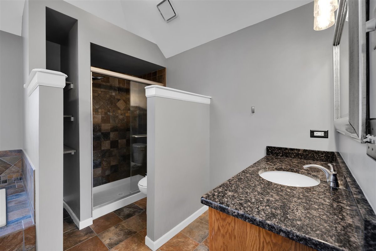 607 Cottage Road Batavia, IL 60510 - Photo 24 of 36 a bathroom with a granite countertop sink and a mirror