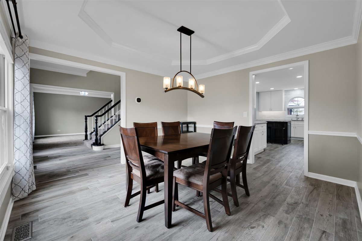 607 Cottage Road Batavia, IL 60510 - Photo 3 of 36 a dining room with furniture a chandelier and wooden floor