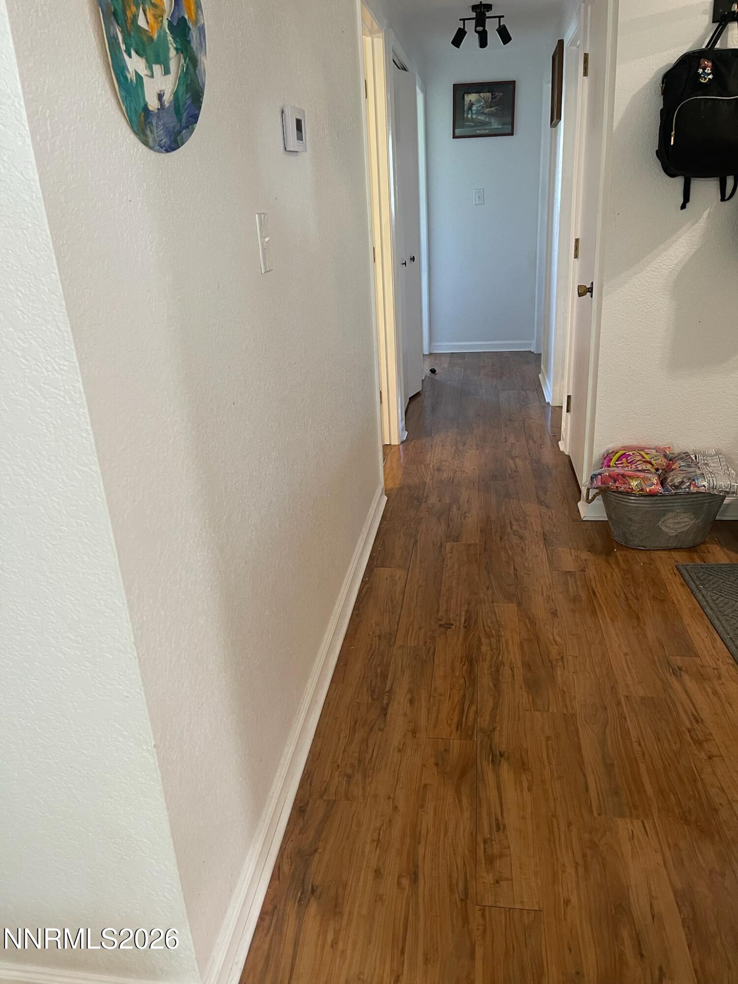 334 Kay Way Yerington, NV 89447 - Photo 15 of 22 a view of a hallway with wooden floor and a bathroom