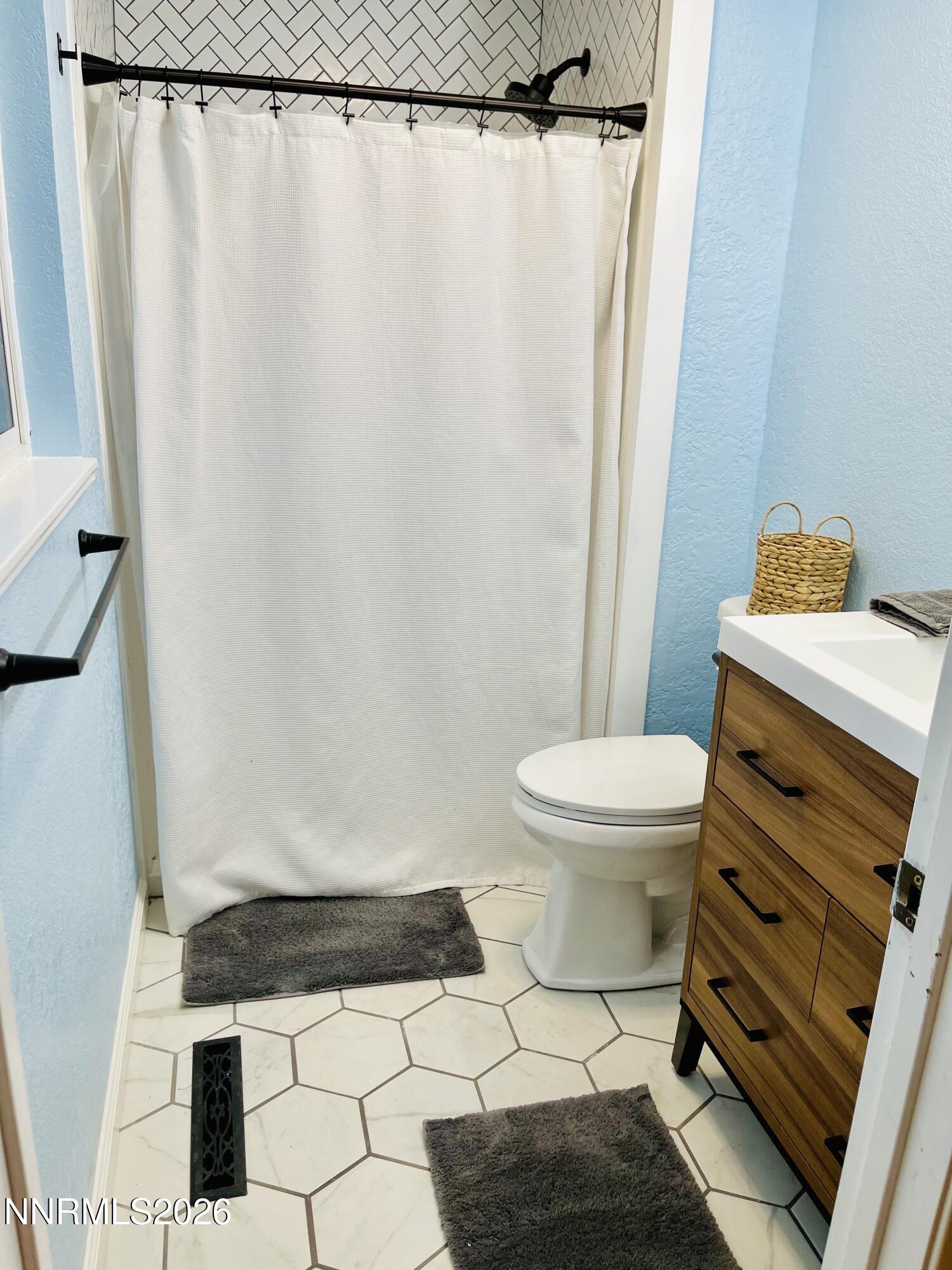 334 Kay Way Yerington, NV 89447 - Photo 16 of 22 a bathroom with a toilet and a shower curtain