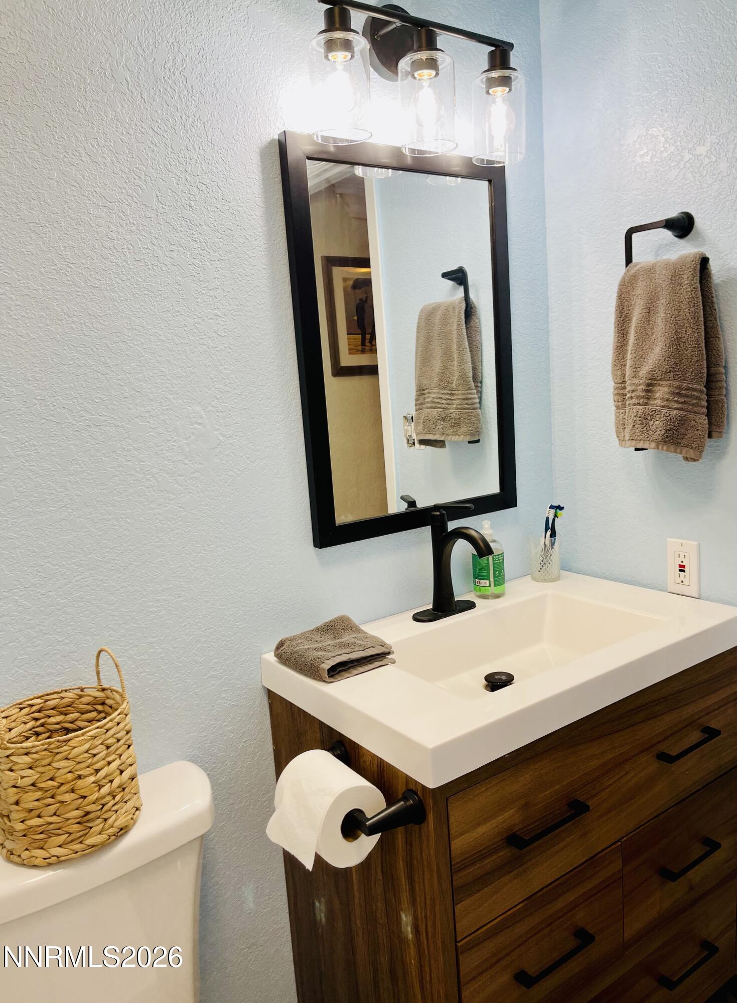 334 Kay Way Yerington, NV 89447 - Photo 17 of 22 a bathroom with a sink and a mirror