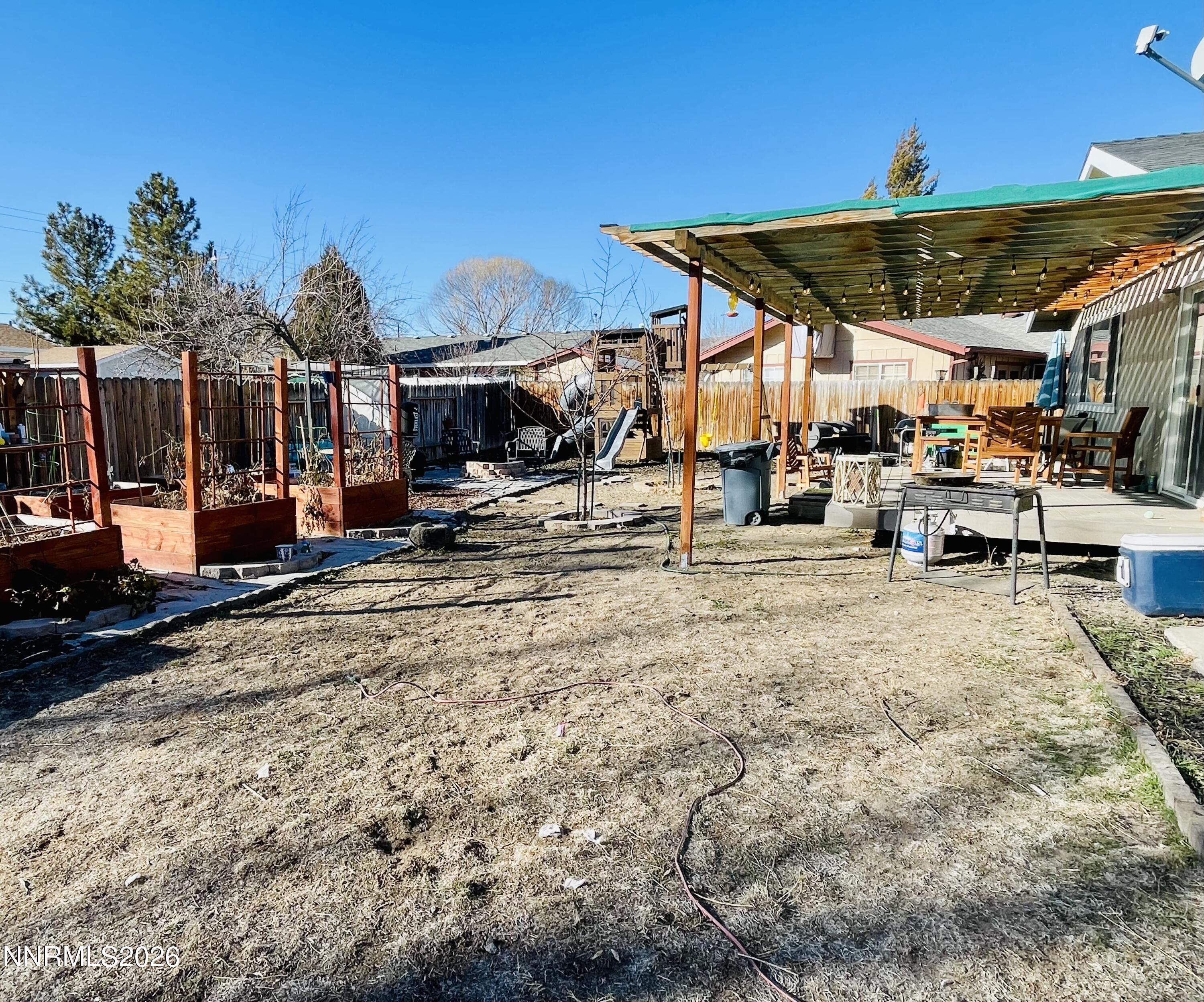 334 Kay Way Yerington, NV 89447 - Photo 21 of 22 a view of a patio with a table and chairs under an umbrella