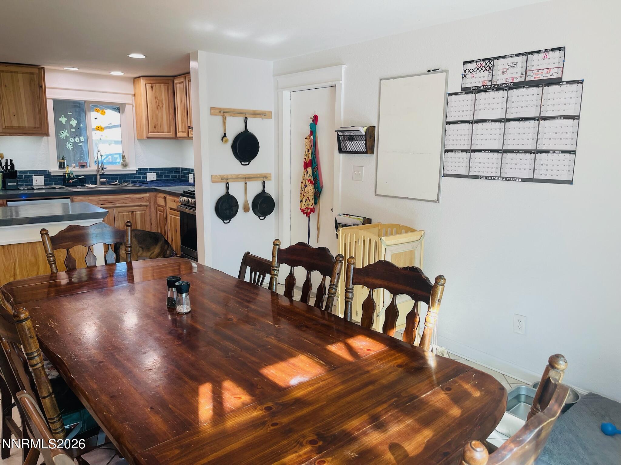 334 Kay Way Yerington, NV 89447 - Photo 6 of 22 a kitchen with stainless steel appliances dining table and chairs