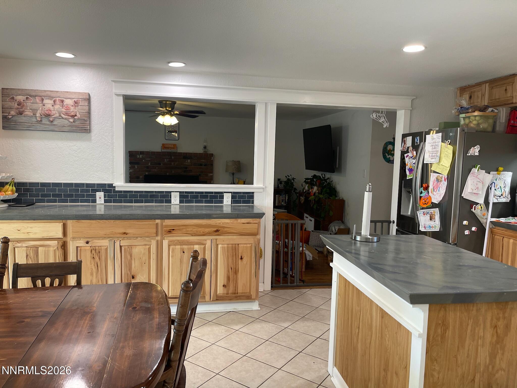 334 Kay Way Yerington, NV 89447 - Photo 7 of 22 a kitchen with stainless steel appliances granite countertop a sink table and chairs