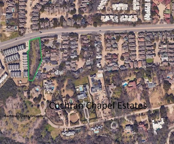 a view of dirt field with trees around