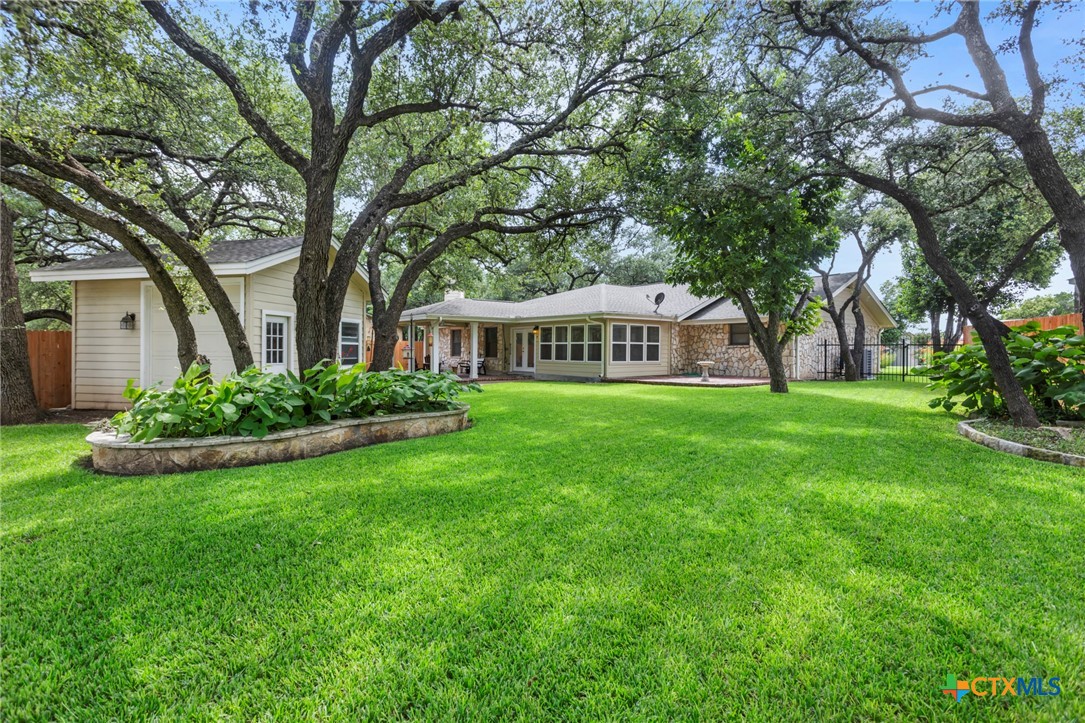 3745-3735 Canyon Heights Road Belton, TX 76513 - Photo 28 of 33 a view of house with garden and tall trees