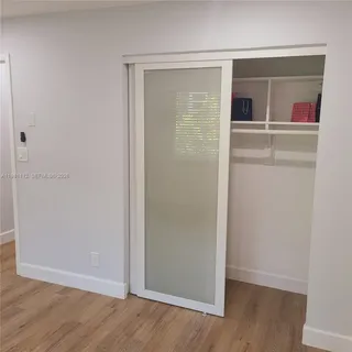 an empty room with wooden floor and a window