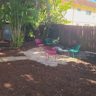 a wooden bench sitting in a yard