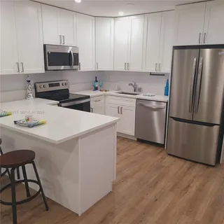 a kitchen with stainless steel appliances a refrigerator stove microwave and sink