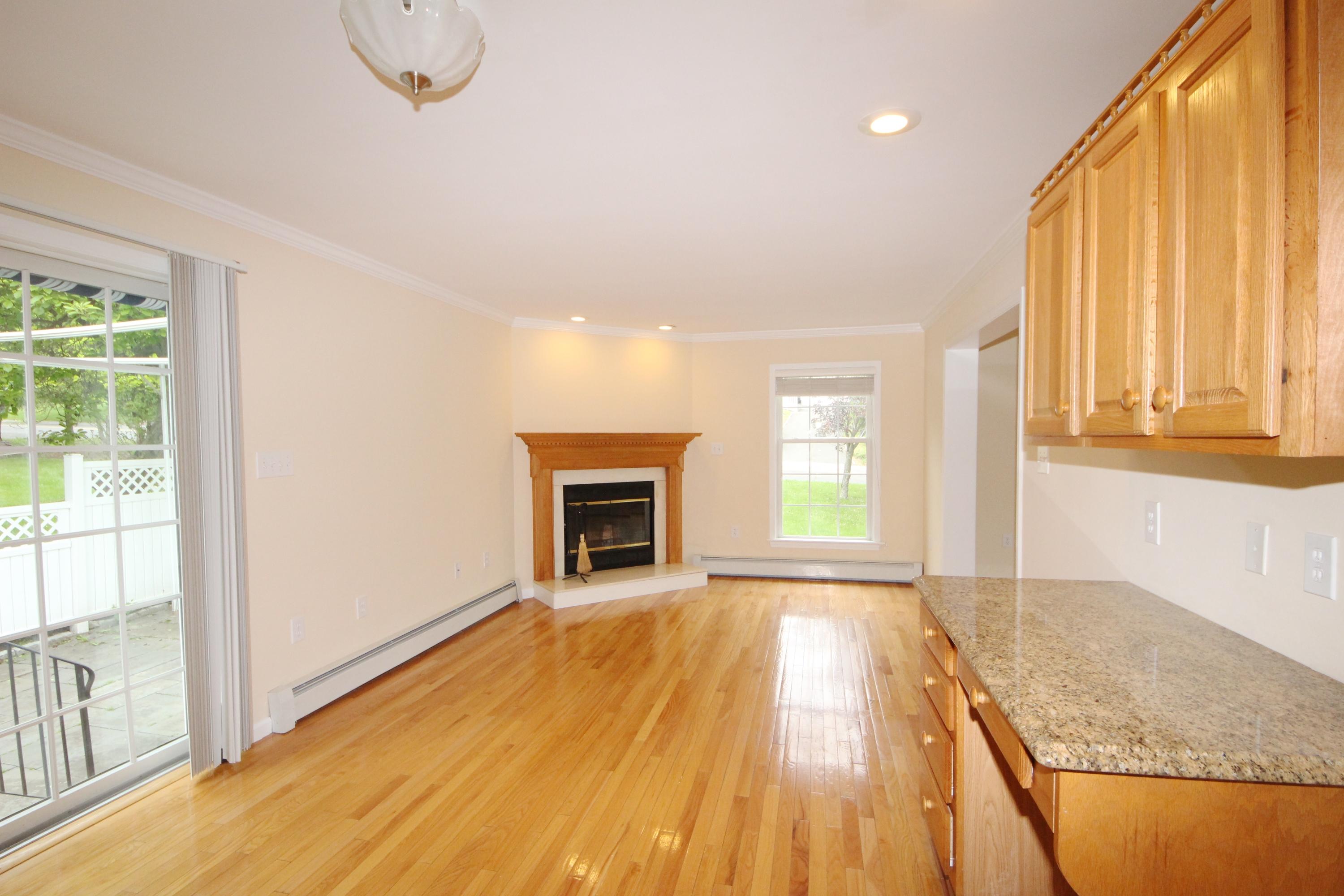 189 Hollow Tree Ridge Road Darien, CT 06820 - Photo 12 of 27 a view of an empty room with a fireplace and a window