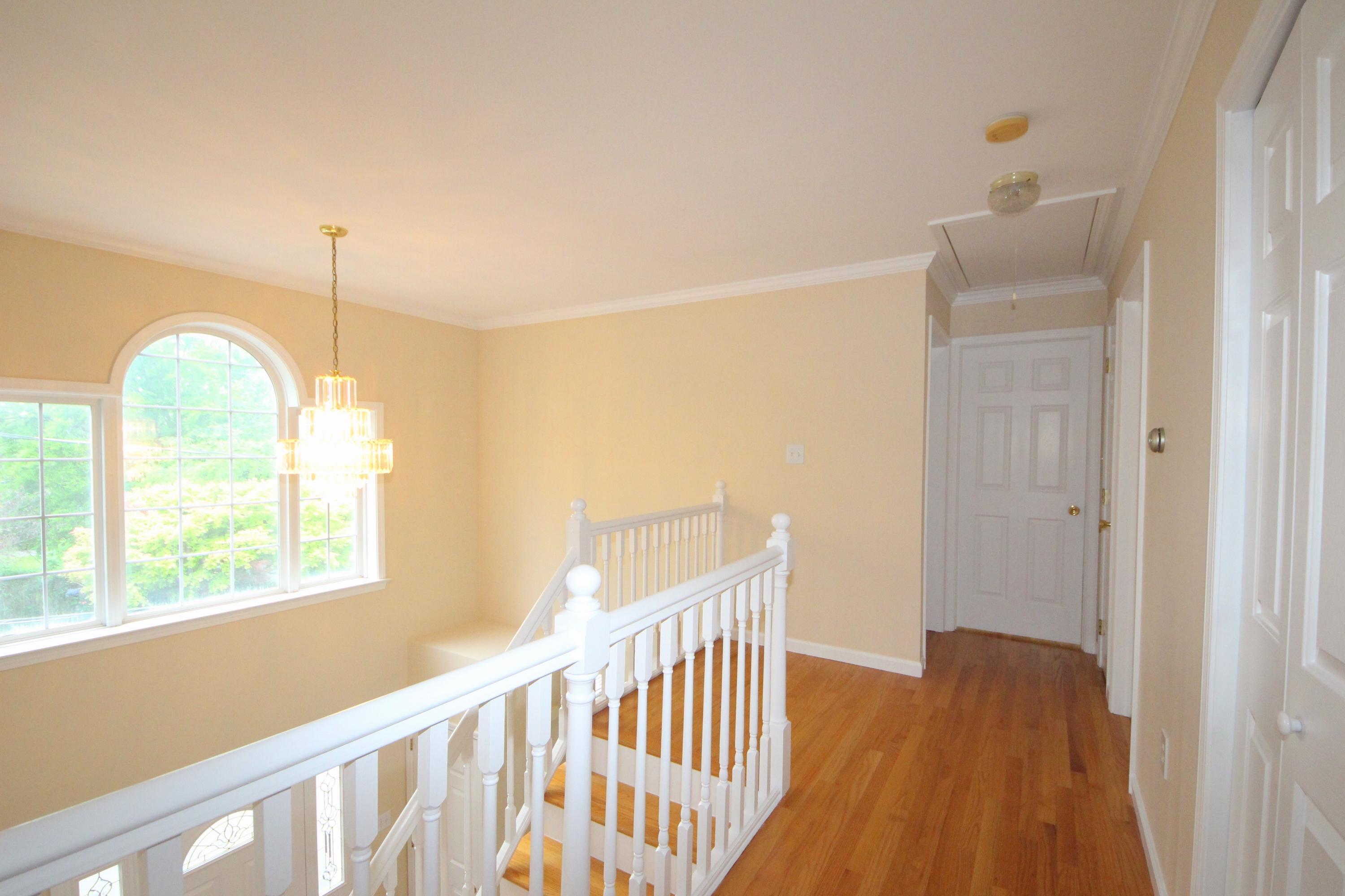 189 Hollow Tree Ridge Road Darien, CT 06820 - Photo 16 of 27 a view of a room with wooden floor and windows