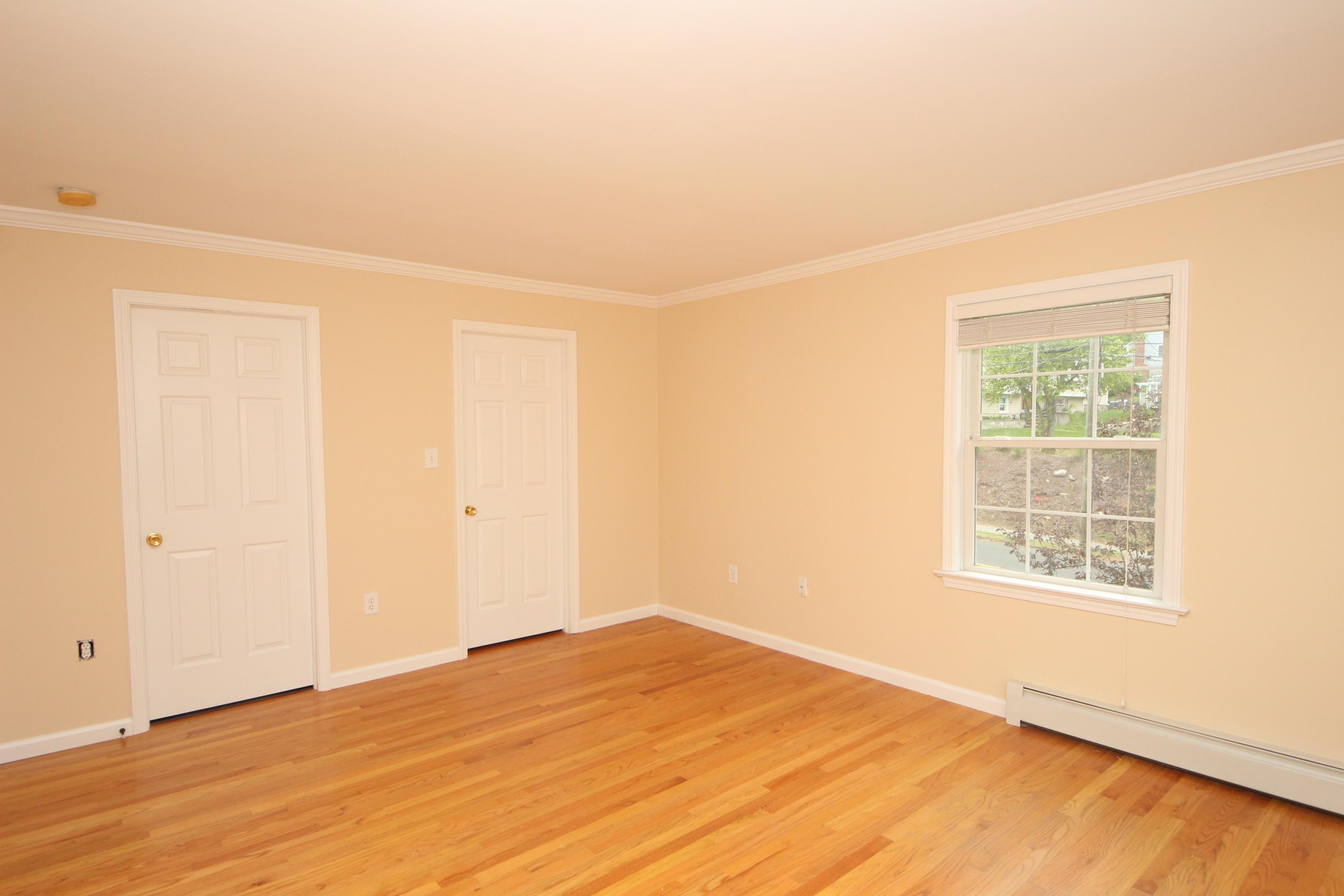 189 Hollow Tree Ridge Road Darien, CT 06820 - Photo 18 of 27 an empty room with wooden floor and windows