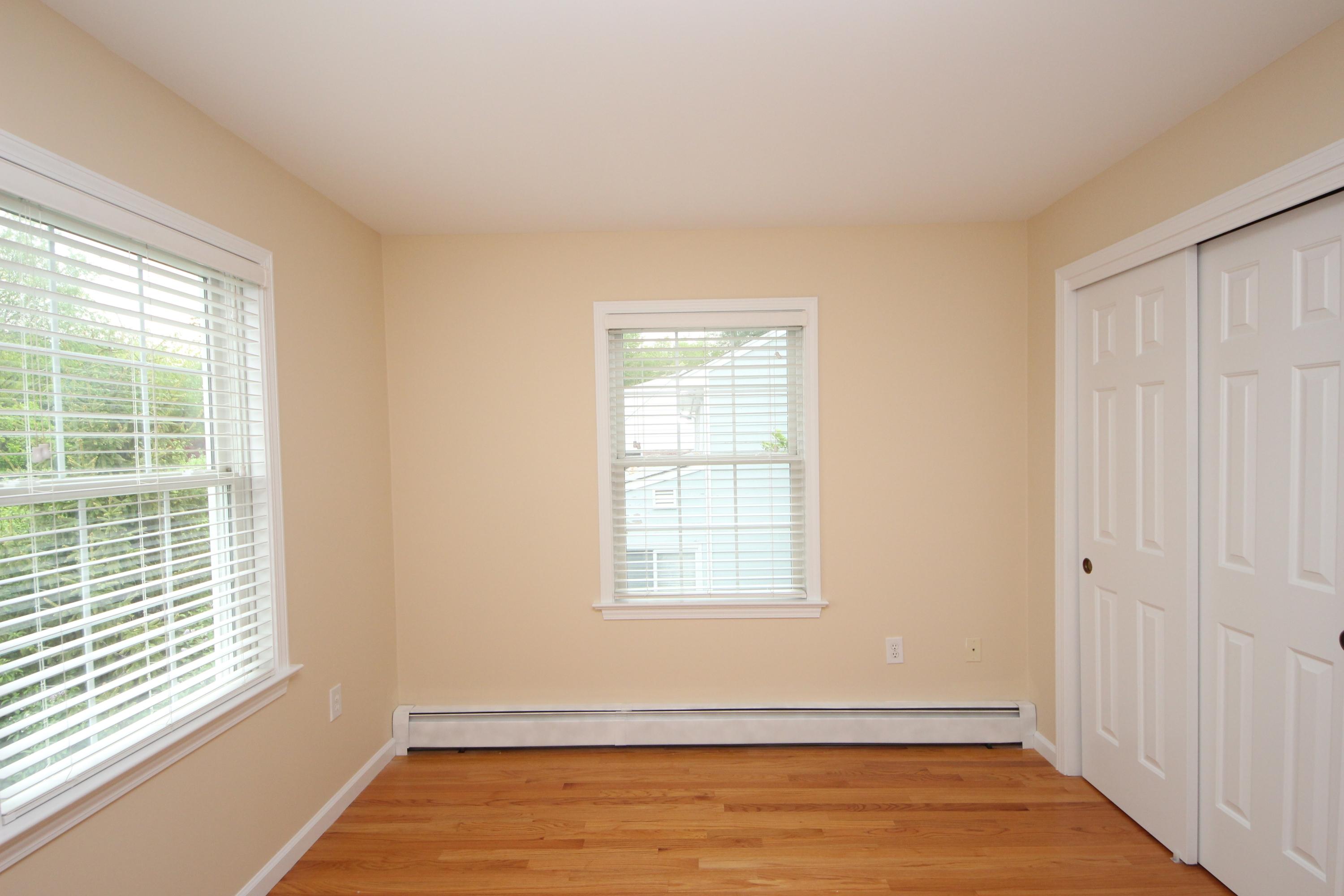 189 Hollow Tree Ridge Road Darien, CT 06820 - Photo 22 of 27 a view of an empty room with wooden floor and a window
