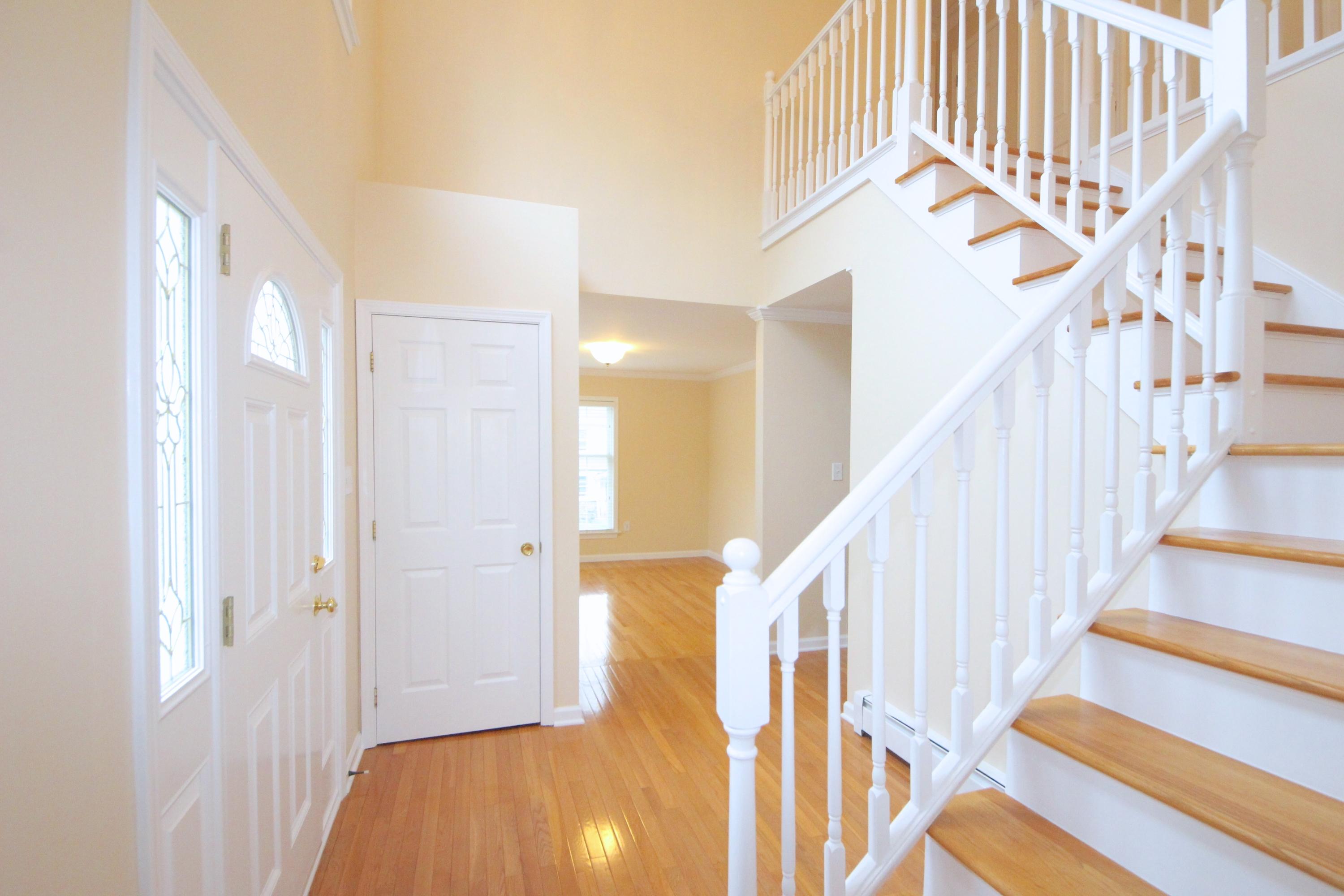 189 Hollow Tree Ridge Road Darien, CT 06820 - Photo 4 of 27 a view of staircase with lots of frames on wall and wooden floor