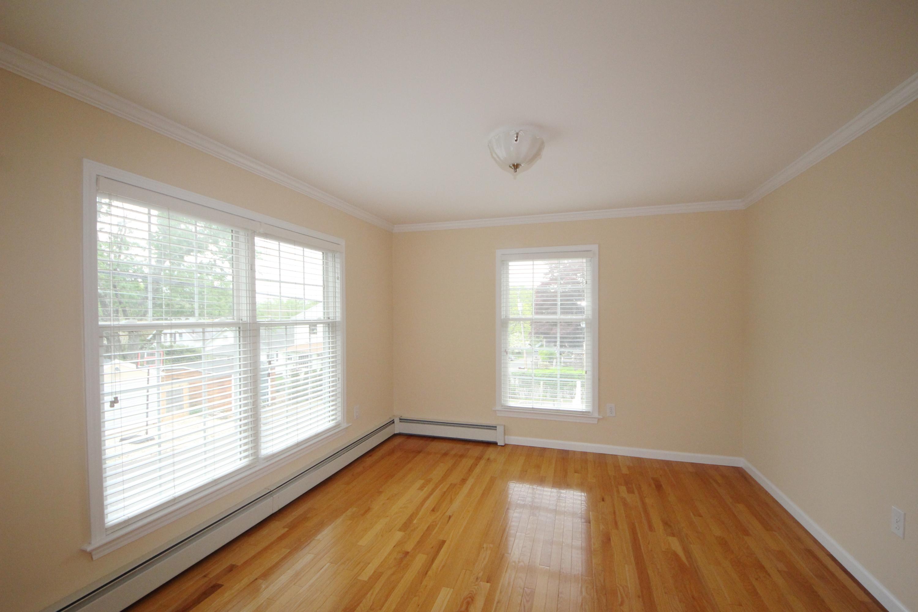 189 Hollow Tree Ridge Road Darien, CT 06820 - Photo 8 of 27 a view of an empty room with wooden floor and a window