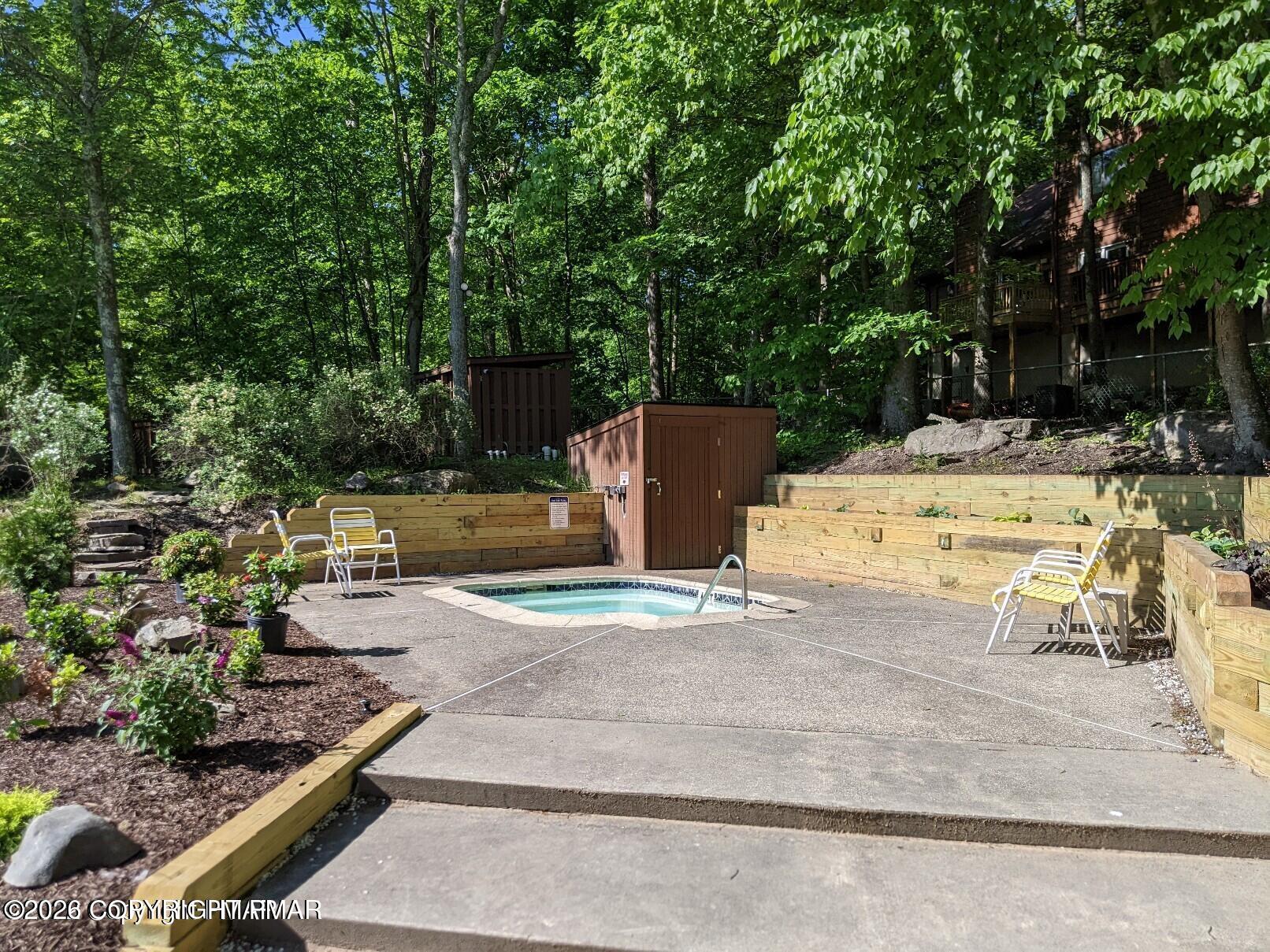 509 Wales Court Bushkill, PA 18324 - Photo 19 of 22 a view of a patio with table and chairs and potted plants