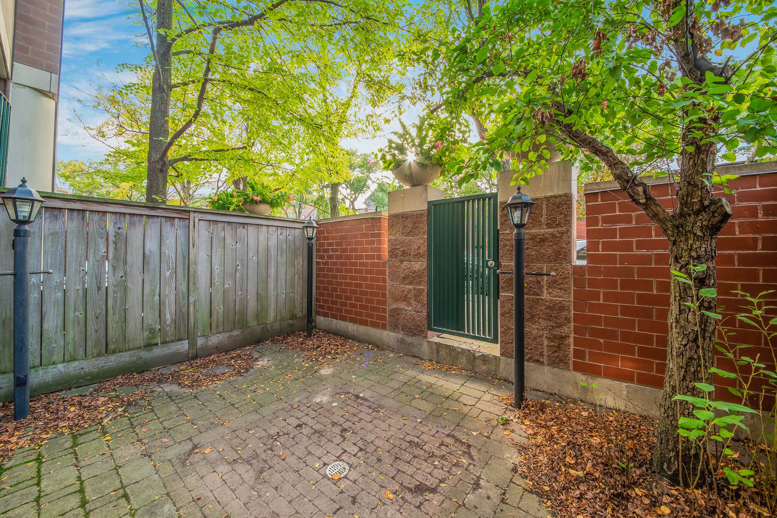 641 West Willow Street, Unit 140 Chicago, IL 60614 - Photo 14 of 22 a backyard of a house with plants and wooden fence