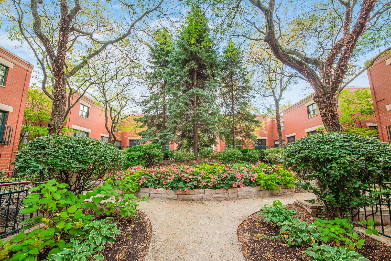 641 West Willow Street, Unit 140 Chicago, IL 60614 - Photo 3 of 22 a pathway of a house with a yard and fountain in middle