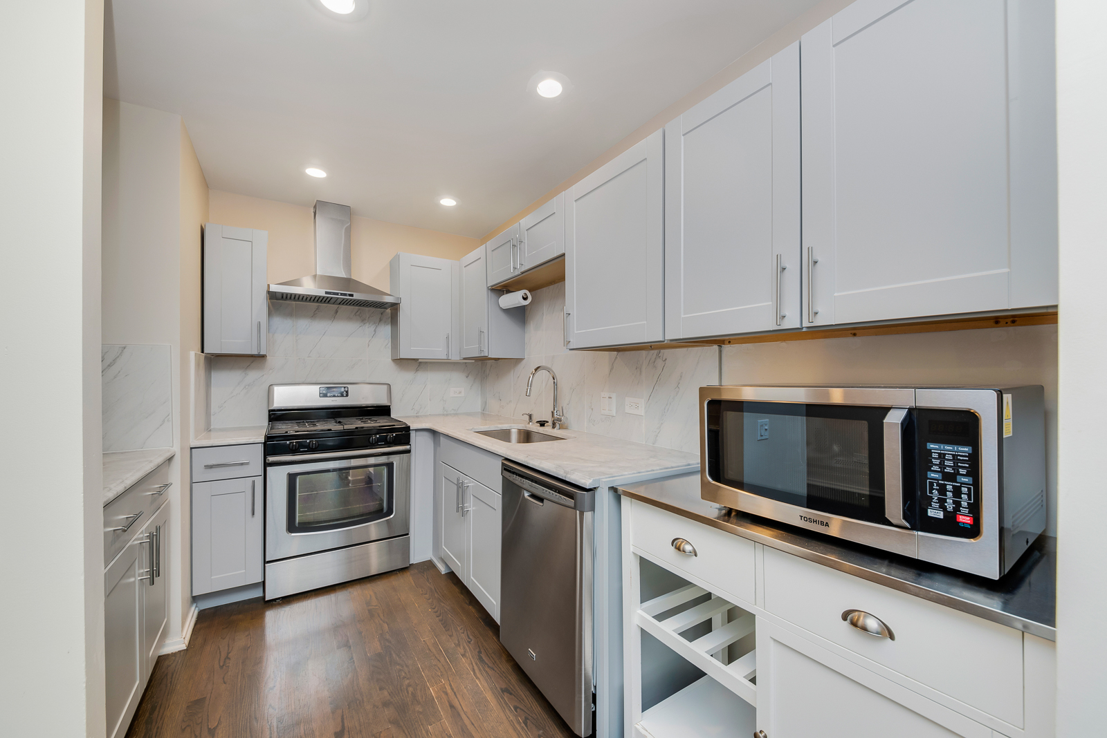 641 West Willow Street, Unit 140 Chicago, IL 60614 - Photo 6 of 22 a kitchen with stainless steel appliances granite countertop a stove a sink and a microwave
