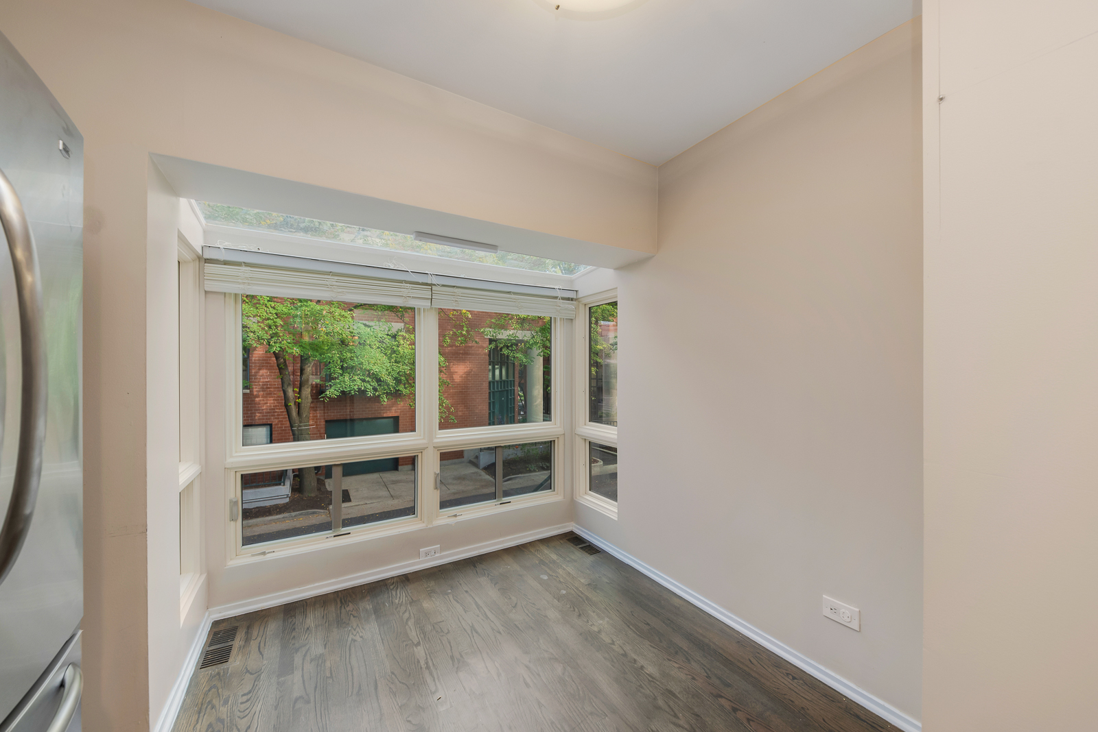 641 West Willow Street, Unit 140 Chicago, IL 60614 - Photo 7 of 22 an empty room with wooden floor and windows