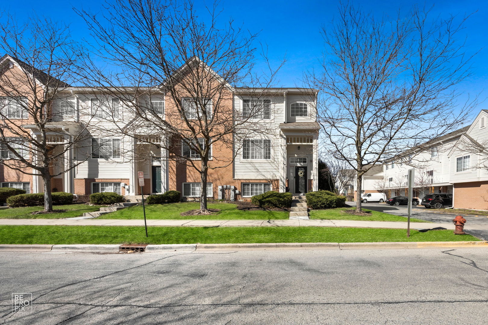 7504 Claridge Drive, Unit E Bridgeview, IL 60455 - Photo 1 of 25 a view of a big building with a big yard and plants