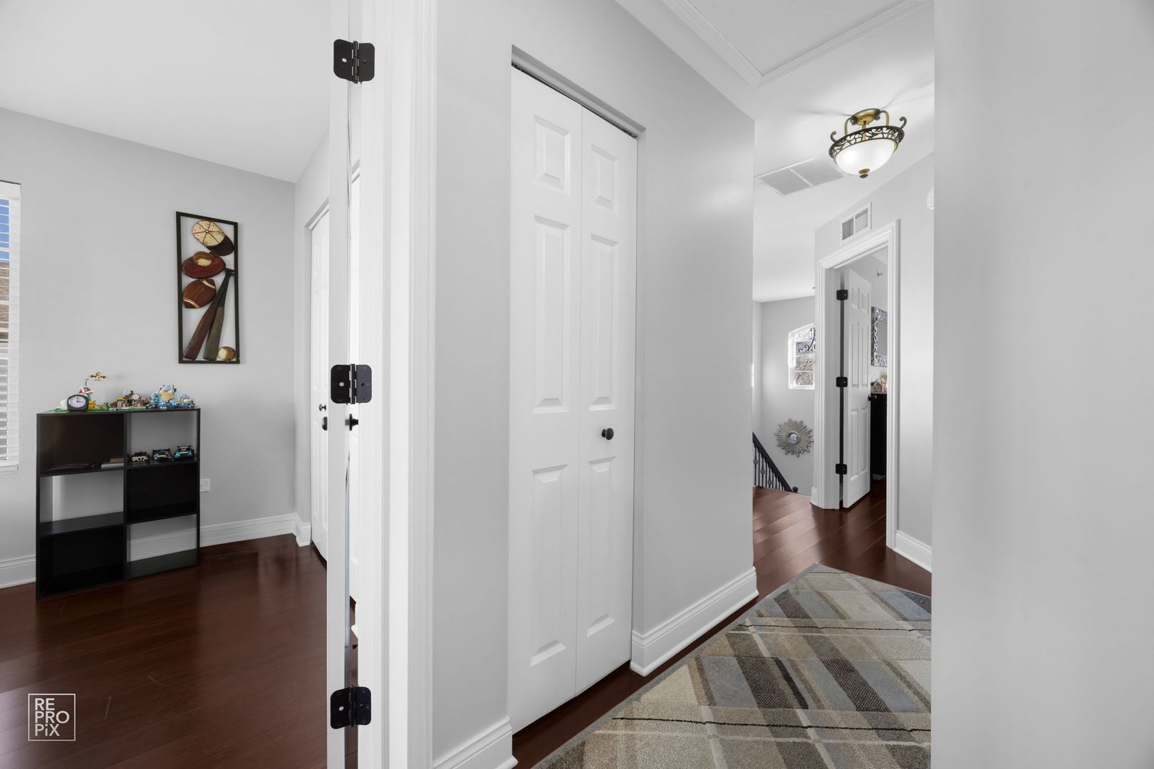 7504 Claridge Drive, Unit E Bridgeview, IL 60455 - Photo 18 of 25 a view of a hallway with wooden floor and workspace