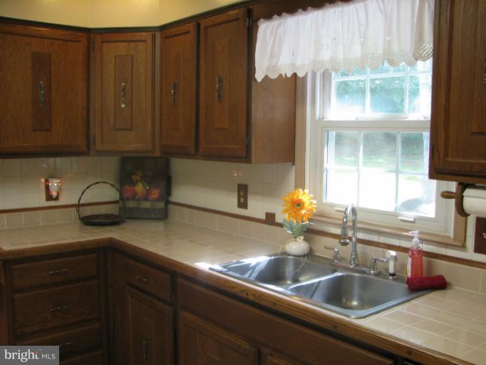 7218 Wilson Road Marshall, VA 20115 - Photo 5 of 30 a kitchen with a sink cabinets and window