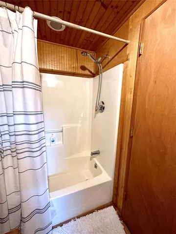 a bathroom with a bathtub and shower