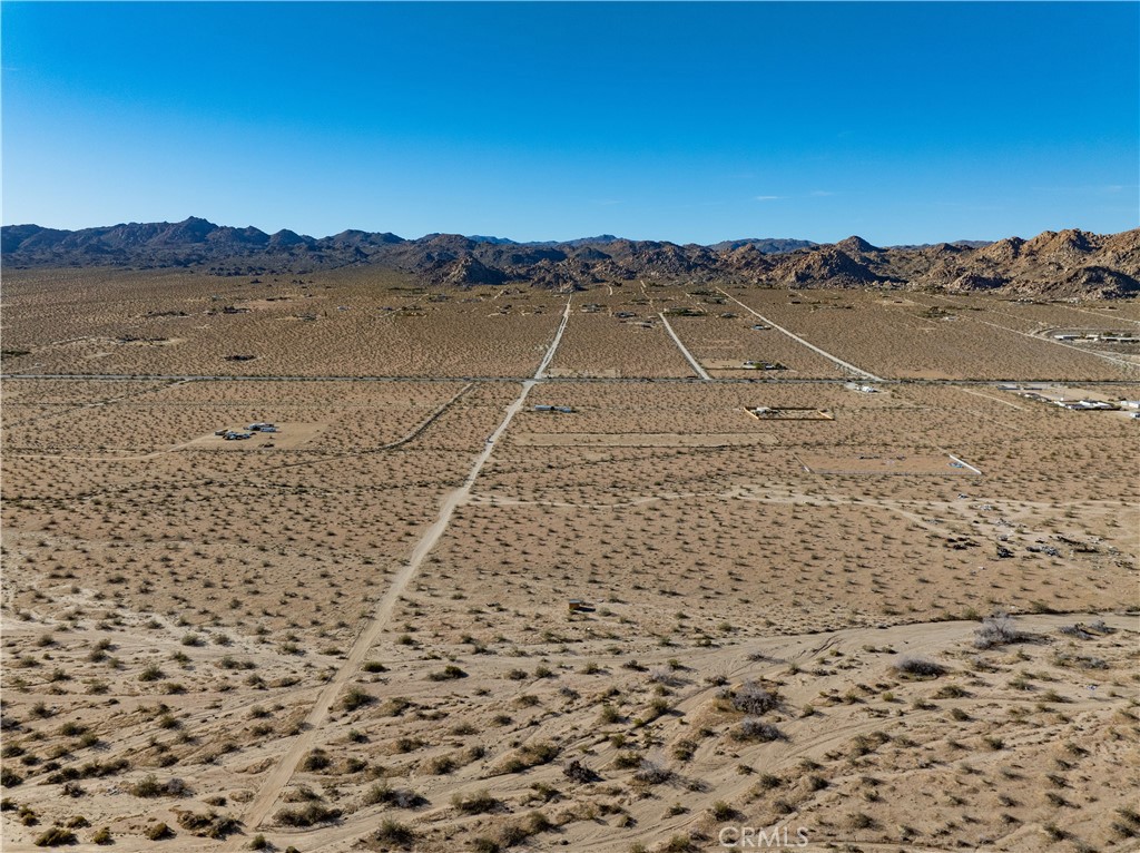 0 Sunever Avenue Joshua Tree, CA 92252 - Photo 21 of 26 a view of a dry yard with mountain