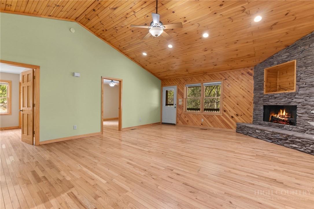 148 Woodby Ridge Road Vilas, NC 28692 - Photo 6 of 33 a view of empty room with wooden floor and fireplace